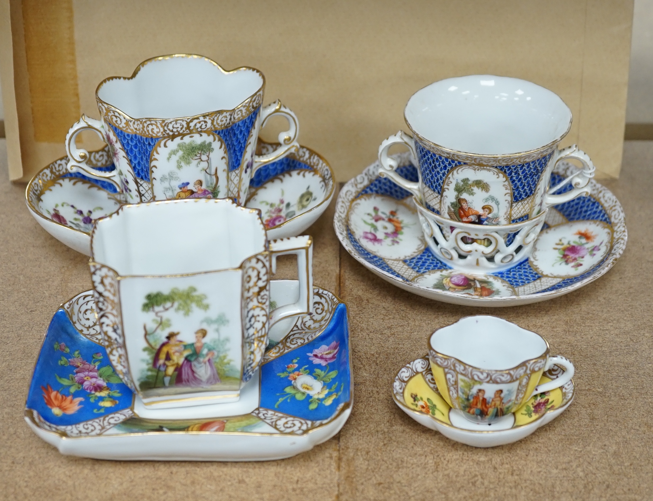 A Crown Dresden porcelain cup and trembleuse saucer, and three other Crown Dresden cups and saucers, largest 14.5cm wide. Condition - good